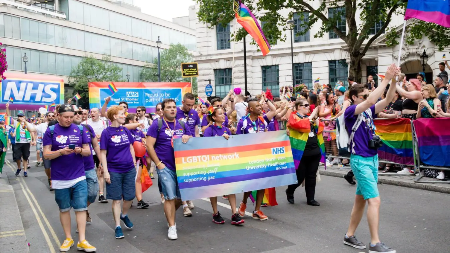 Image of NHS staff marching at a Pride event.