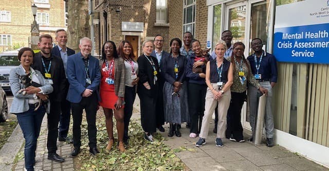 Daniel Elkeles, chief executive of NHS Providers standing with 14 members of the team from CNWL