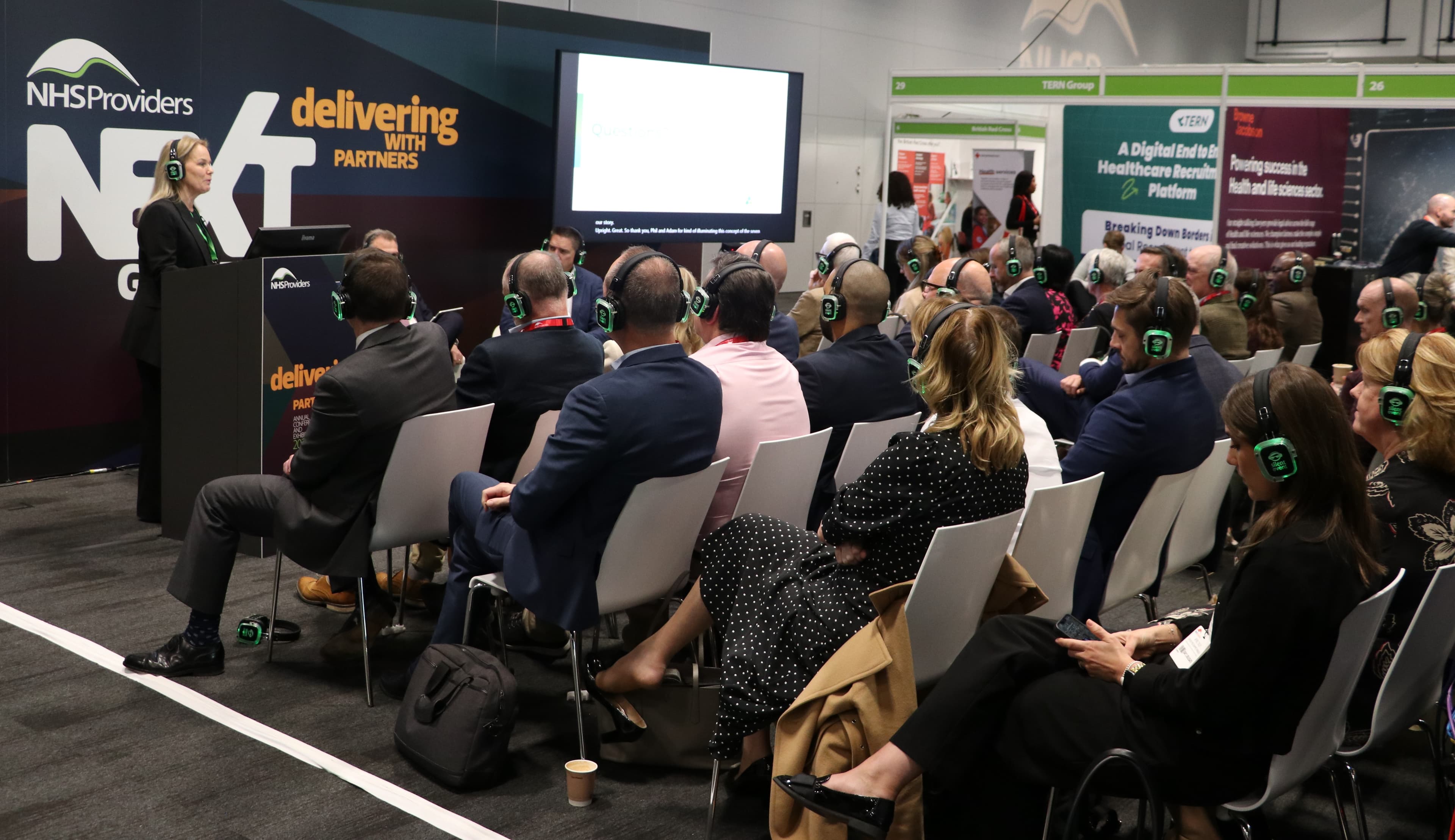 Partner session at NHS Providers Annual Conference with attendees wearing headsets.