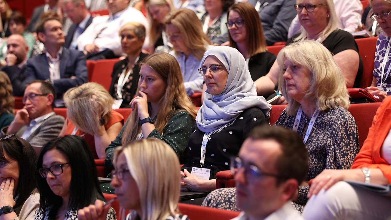 Delegates watching a plenary session